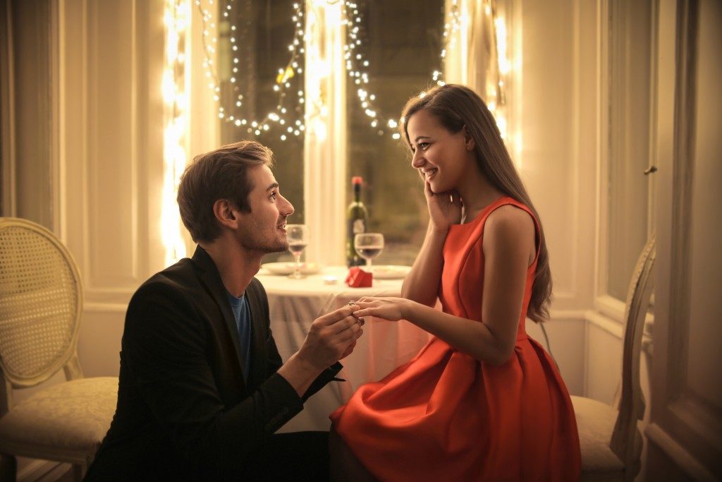 Man proposing in an elegant restaurant