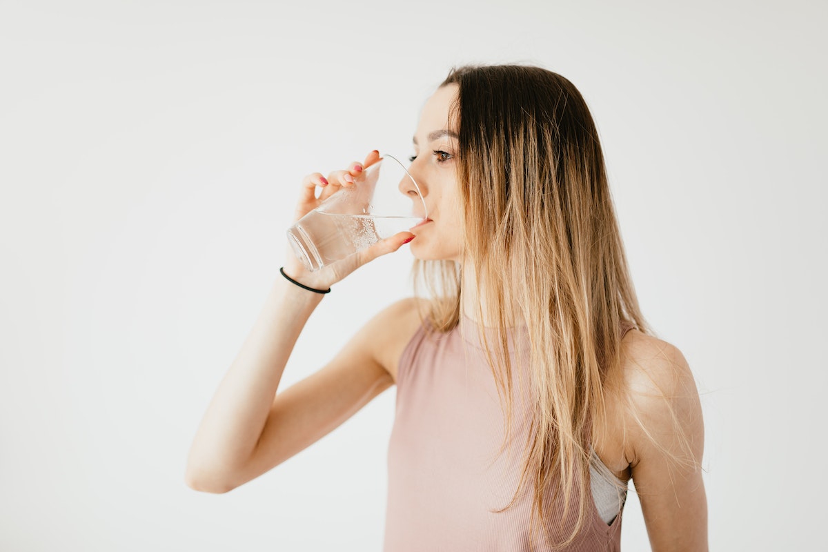 a woman drinking mineral water