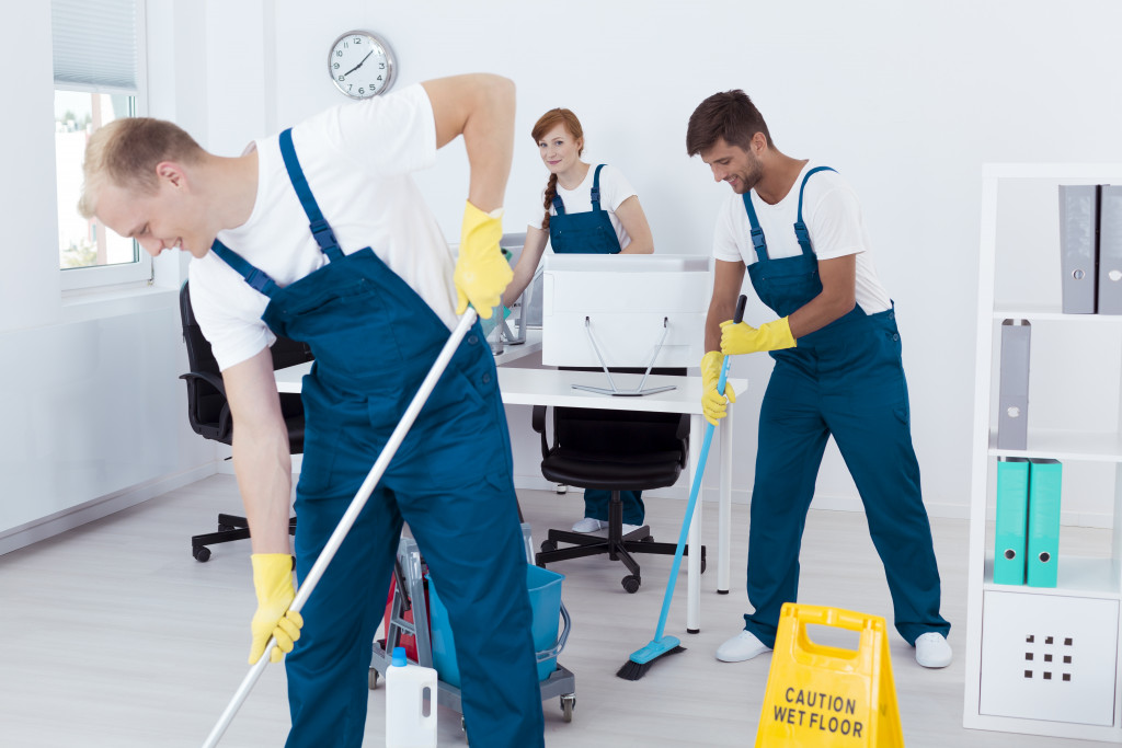 commercial cleaning workers in an empty office